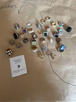 Overhead view of all rings arranged on paper