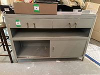 Front view of vintage storage cabinet showing overall structure with drawers, open shelf, and sliding door compartment.