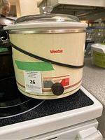 Front view of off-white Weston crock pot with control dial and power cord wrapped around.