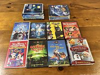 Photo showing stack and spread out DVDs including Frozen, Willow, LEGO Batman, The Incredibles, Very Merry Christmas Sing-Along Songs, Garbage Pail Kids, Chitty Chitty Bang Bang, and Christmas Classics