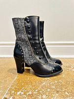 Left side view showing patterned fabric shaft, decorative buttons and block heel