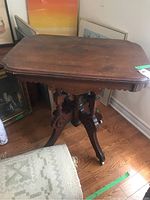 Front and side view of Eastlake parlour table showing scalloped apron and rectangular top with rounded edges.