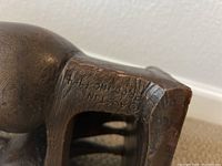 Close-up of engraved artist signature and date on base - 'Austin Henry 1964'