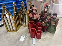 Photo showing entire lot with cathedral mirror, four choral figurines, four red flameless candles, and remote control placed on the floor.