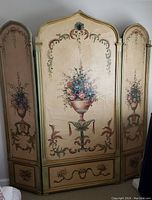 Full front view showing middle and side panels with floral urn paintings and decorative borders.