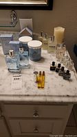Overview photo showing all parfum bottles and containers on a marble surface.