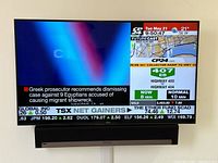 Front view of Samsung TV powered on with Sonos bar beneath