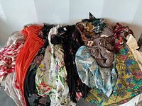 Lot of women's floral dresses in a variety of colors and patterns shown together