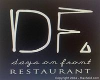 Close-up photo of the gift certificate with the Days on Front Restaurant logo and name in white on black background.