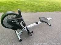 Side view of the XTERRA ERG400 rowing machine showing the black housing, seat, and rail.