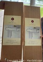 Packed boxes of identical bath towel racks from President's Choice, showing label with product image and brand.