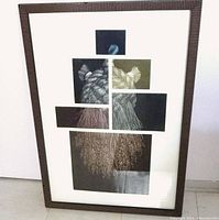 Front view of framed mezzotint print showing collage arrangement of dark panels with white etched designs; brown striped wooden frame.