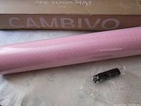 Rolled pink CAMBIVO yoga mat next to its box and a sealed black strap.