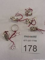 Overview of six sterling silver rings with red size tags