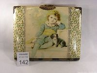 Front view of antique Victorian photo album with celluloid cover featuring a child and dog image, floral side patterns, and brass corner fittings.