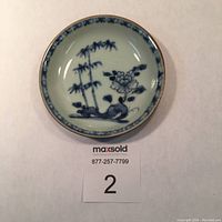 Top view of porcelain saucer showing full bamboo and peony decoration