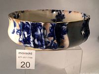 Side profile of dish showing fluted edge and blue floral design