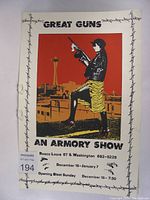 Photo of the full "Great Guns" armory show poster showing a stylized woman with a rifle and city skyline background.