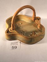 Ceramic tray with bamboo handles, showing front and handle detail in warm earth-tone glaze