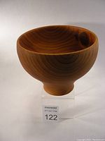 Front angle view of the turned cedar bowl showing the wood grain and rounded shape.