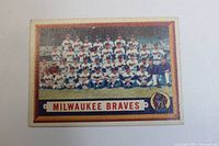 Front of the 1957 Topps Milwaukee Braves Team Card showing the entire team posed in rows wearing white uniforms with