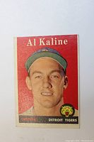 Front side of the 1958 Topps baseball card with portrait of Al Kaline wearing a Detroit Tigers cap, red background, and team logo.