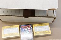 Open box showing rows of factory sealed 1987 Donruss Baseball card packs and two sample cards with player statistics.
