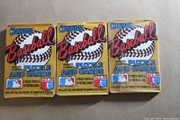 Front view of three unopened 1987 Donruss Baseball wax packs, each labeled with 'Baseball Puzzle and Cards' and featuring Roberto Clemente on the front.