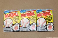 Front view of three sealed 1989 Fleer Baseball wax packs showing the colorful logo, baseball image, and pack details.
