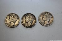 Obverse side of three Mercury Dimes, showing winged Liberty Head with dates of 1941, 1943, and 1944.
