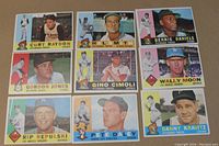 Front view of all 9 baseball cards laid out on a flat brown surface, showing player images and teams.
