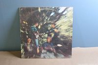 Front cover of the Creedence Clearwater Revival Bayou Country vinyl LP, showing blurred image of band members in a wooded area.