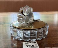 Assembled jar on wooden table with auction label visible