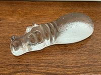 Side view of the clear glass hippopotamus showing its length and textured surface.