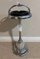 Full view of the vintage chrome floor standing ashtray showing the pedestal with akro agate base and black glass ashtray insert.