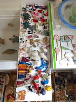 Photo of felt ornaments spread on a table showing various animals and character figures