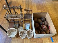Overview of all lot items on hardwood floor: twig bench, twig chair, spindle chair, yellow rocker, wicker seating and box of maracas.