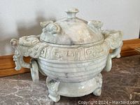 Front view of jar showing lid finial, body and dual dragon head handles