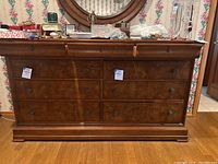 Full front view of dresser showing all nine drawers and items on top