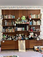 Full front view of assembled teak wall unit with books and accessories