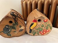 Front view showing the two hand-painted birdhouses with different bird and nature designs.