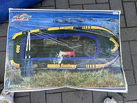 Box front showing product image and accessories including oars, pump, and repair patch.