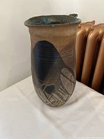 Full side view of the large ceramic vase showing color and design.