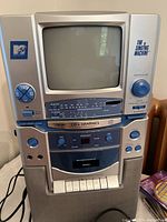 Front view of MTV The Singing Machine karaoke system showing built-in CRT screen and control panel.
