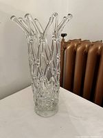 Side view of the clear vintage lattice glass vase showing intricate crisscross pattern and elongated glass tips at the top rim.