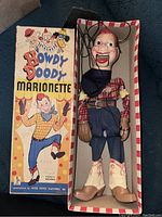Full view of Howdy Doody marionette puppet inside original box, showing puppet and box with artwork.