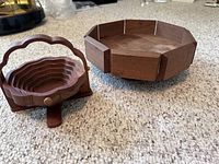 Photo showing the MCM walnut pedestal server next to the collapsible basket on carpeted floor.