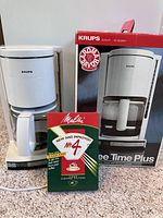 KRUPS CoffeeTime Plus coffee maker in white and gray with original box and Melitta coffee filters in front