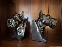 Front and side view of Scottish Terrier cast metal bookends showing detailed dog head design and felt lined bottom.
