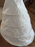 Full view of the white hoop slip unfolded showing fabric and shape.